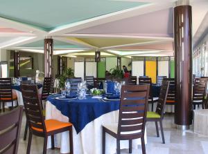 a dining room with a blue table and chairs at Torre Del Sole in Terracina