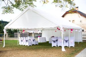 a white tent with white chairs and tables at Hotel Lužnice in Planá nad Lužnicí