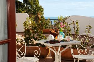 a table with a teddy bear sitting on it on a balcony at La Locanda Azzurra in Sanremo