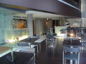 a dining room with tables and chairs in a restaurant at Hotel Madanis in Barcelona