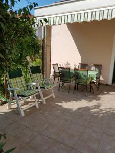 a group of chairs and a table on a patio at Apartments Aurora Borik in Zadar
