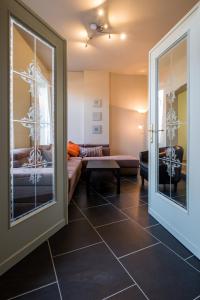 a living room with a couch and a table at Sekowa-lodge in Geraardsbergen