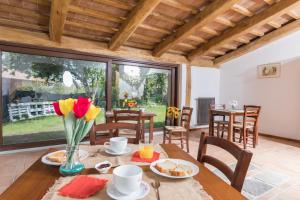 a dining room with a table with flowers on it at B&B Podere Legnotorto in Castel del Piano