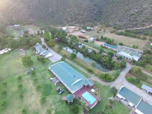 an aerial view of a house with a tennis court at De Oude Meul Country Lodge & Restaurant in Oudtshoorn