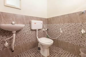 a bathroom with a toilet and a sink at Mad about Coco Yoga & Beach Retreat in Varkala +37 photos