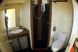 a bathroom with a toilet and a sink and a shower at Moonstone Studio in Haad Rin