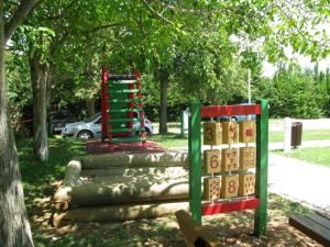 a playground in a park with a tree at Erks Premantura in Premantura