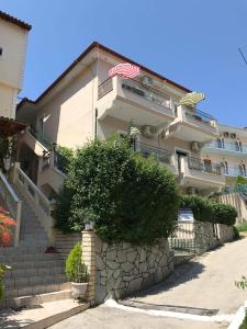 an apartment building with stairs and an american flag at Dreams Studios Parga in Parga
