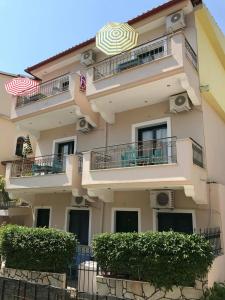 a building with balconies and an umbrella on it at Dreams Studios Parga in Parga