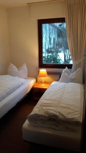 a hotel room with two beds and a window at Winterberg-Hasewinkel in Winterberg