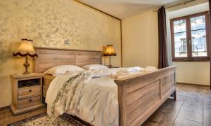
a bedroom with a bed and a dresser at Hiša Linhart, Hotel & Restaurant in Radovljica
