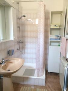 a bathroom with a shower and a sink and a tub at Apartment Tinna in Cres