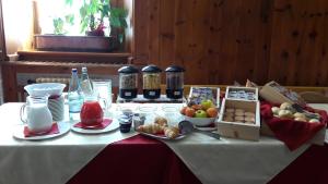 a table with a white table cloth with food on it at B&B Vecchio Borgo in Bormio