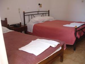 Postel nebo postele na pokoji v ubytování Hotel Inomaos