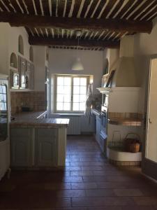 a large kitchen with a large island in the middle at maison de charme en Luberon in Grambois