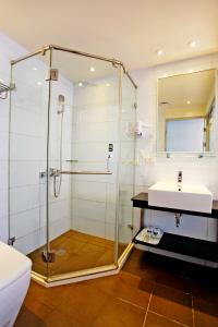 a bathroom with a glass shower and a sink at Taitung Yes Hotel in Taitung City