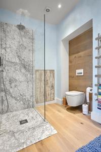 a bathroom with a shower and a bath tub at Blue Door Apartment in Augustów