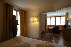 Ένα ή περισσότερα κρεβάτια σε δωμάτιο στο Alpen Suite Hotel