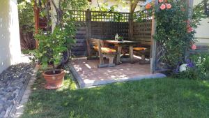 a patio with a table and chairs in a garden at Haus Salzmann in Pfunds