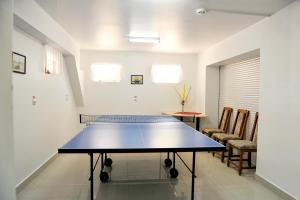 a ping pong table in the middle of a room at Vila Rusidava in Eforie Nord