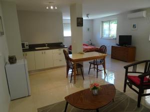a kitchen and living room with a table and chairs at Magnificent studio in Zichron yaakov sea view and garden in Zikhron Ya‘aqov