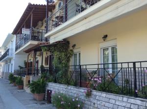 a building with balconies and flowers on a street at Studios Nopi-Zoi in Skiathos Town
