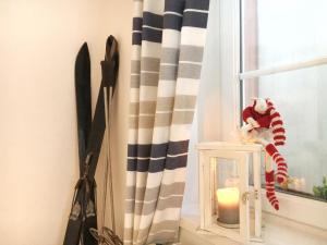 a window with a candle and a stuffed animal on a window sill at La Clé d'Alsace in Sainte-Marie-aux-Mines