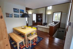 a living room with a table and a couch at Casa do Vizinho in Porto Judeu +18 photos