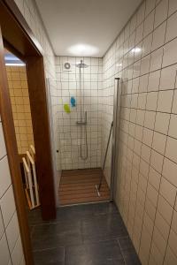 a bathroom with a shower with a wooden floor at Casa do Vizinho in Porto Judeu