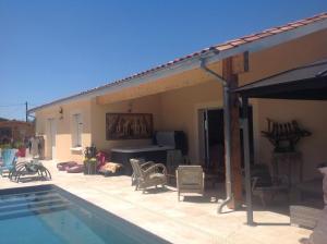 a patio with a swimming pool and a house at Le sang des vignes in Monbazillac