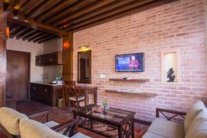 a living room with a brick wall at Hotel Marshyangdi in Kathmandu