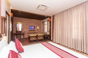 a room with a bed and a living room at Hotel Marshyangdi in Kathmandu