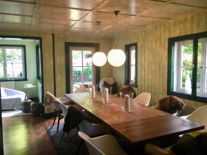 a dining room with a wooden table and chairs at Alpchalet Oberstdorf in Oberstdorf