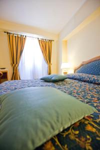 Postel nebo postele na pokoji v ubytování Hotel Elimo