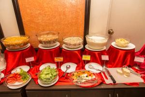 a buffet with bowls of food and plates of food at Hotel Marshyangdi in Kathmandu