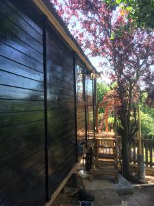 a screened in porch of a house with a tree at Cherry Tree Gypsy Wagon Sibford Gower in Banbury