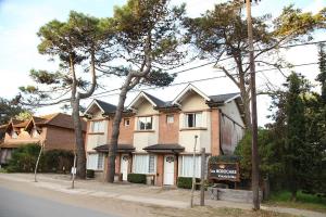 a house with a sign in front of it at Complejo las Morochas in Valeria del Mar