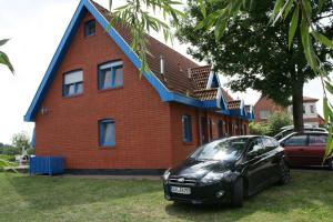 a black car parked in front of a brick house at Zur-alten-Schmiede-I-Links in Boltenhagen