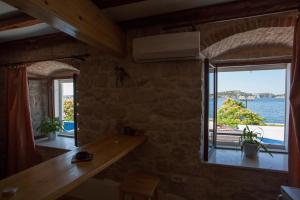 a room with a large window with a view of the water at Apartment Riva in Šibenik +4 photos