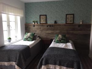 a bedroom with two beds and a window at STF Andrarum Kuskahusen Hostel in Andrarum-Brosarp