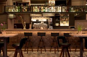 a bar with bar stools in a restaurant at Allotino Pension in Nafplio