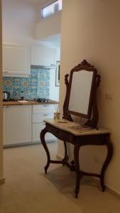 a mirror sitting on a table in a kitchen at Sciala' in Taormina +40 photos