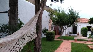 a hammock in the yard of a house at Casa da Talhada - Stone House in Óbidos