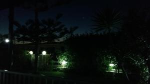 a house at night with lights in the yard at El Zohour Chalet North Coast in El Alamein