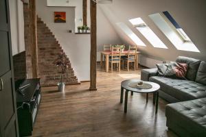 a living room with a couch and a table at Apartament Przy Rynku in Opole