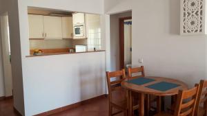 a kitchen with a table and chairs in a room at Charming Monte da Eira- one bedroom in Tavira