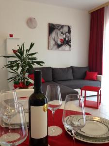 a bottle of wine sitting on a table with wine glasses at Villa Jasmin in Bol