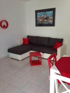 a living room with a couch and a red stool at Villa Jasmin in Bol