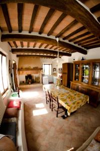 a large room with a table and a kitchen at Podere Remignoli in San Gimignano