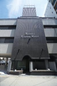 a building with a sign on the side of it at Tennoji Lagoon Hotel in Osaka